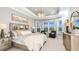 Spacious primary bedroom featuring a tray ceiling, chandelier, and large windows with beautiful views at 6237 Plateau Ct, Bradenton, FL 34203