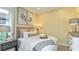Cozy bedroom featuring a plush bed with decorative pillows, soft lighting, and stylish artwork at 6237 Plateau Ct, Bradenton, FL 34203