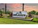 Elegant Esplanade at the Heights community sign amid manicured landscaping and palm trees under a colorful sky at 6237 Plateau Ct, Bradenton, FL 34203