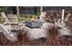 Outdoor fire pit with Adirondack chairs, perfect for gathering with friends, amid manicured landscaping at 6237 Plateau Ct, Bradenton, FL 34203