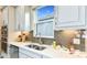 Kitchen featuring stainless steel appliances, light granite countertops, light gray cabinets and neutral backsplash at 6237 Plateau Ct, Bradenton, FL 34203