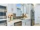Kitchen featuring stainless steel appliances, light granite countertops, light gray cabinets and neutral backsplash at 6237 Plateau Ct, Bradenton, FL 34203