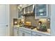 Modern kitchen featuring stainless steel appliances and gray cabinets with upgraded hardware and decorative accessories at 6237 Plateau Ct, Bradenton, FL 34203