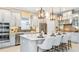 Open kitchen featuring a large island with seating, stainless appliances, gray cabinets and upgraded countertops at 6237 Plateau Ct, Bradenton, FL 34203