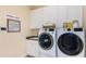 Well-organized laundry room with white cabinets, modern washer and dryer, and a sink area at 6237 Plateau Ct, Bradenton, FL 34203