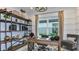 Well-lit office with a wooden desk, decorative shelving, and a comfortable chair at 6237 Plateau Ct, Bradenton, FL 34203