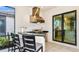 Outdoor kitchen featuring a stainless steel grill, black granite countertops, and bar seating at 6237 Plateau Ct, Bradenton, FL 34203