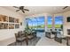 Covered patio with outdoor dining set, comfortable seating, and a scenic lake and pool view at 6237 Plateau Ct, Bradenton, FL 34203