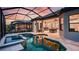 Exterior view of a luxury home highlighting a screened-in pool, spa, and covered outdoor living area at 6237 Plateau Ct, Bradenton, FL 34203