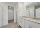 Bathroom featuring a double vanity with granite countertop and a walk-in shower at 31622 Malbec Ln, Brooksville, FL 34602