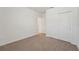 An empty bedroom with neutral carpet and closet space at 31622 Malbec Ln, Brooksville, FL 34602