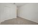 Empty carpeted bedroom with closet space and white trim at 31622 Malbec Ln, Brooksville, FL 34602