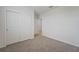 An empty bedroom with neutral carpet and white walls and doors at 31622 Malbec Ln, Brooksville, FL 34602