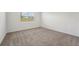 Carpeted bedroom with a view from the window at 31622 Malbec Ln, Brooksville, FL 34602
