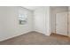Bright bedroom featuring carpeted floors, a window with blinds, and a closet at 31622 Malbec Ln, Brooksville, FL 34602