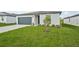 Single Gathering home with a well kept lawn and a driveway leading to a two-car garage at 31622 Malbec Ln, Brooksville, FL 34602
