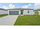A single Gathering home with a well kept lawn and a driveway leading to a two-car garage at 31622 Malbec Ln, Brooksville, FL 34602