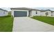 Single Gathering home with a well kept lawn, driveway and attached two-car garage at 31622 Malbec Ln, Brooksville, FL 34602