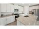 Modern kitchen with stainless steel appliances, granite counters, white cabinets and tile floors at 31622 Malbec Ln, Brooksville, FL 34602