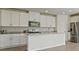 Well-lit kitchen with white cabinets, granite countertops, and stainless steel appliances at 31622 Malbec Ln, Brooksville, FL 34602