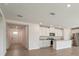 Open-concept kitchen features white cabinets, granite countertops, and stainless steel appliances at 31622 Malbec Ln, Brooksville, FL 34602