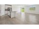 Open living space with tile flooring connecting the kitchen with a view of the backyard at 31622 Malbec Ln, Brooksville, FL 34602