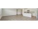 Open concept living area with tile flooring, white walls and kitchen island at 31622 Malbec Ln, Brooksville, FL 34602