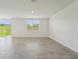 Spacious open living area with sliding glass door leading to the backyard and large windows at 31622 Malbec Ln, Brooksville, FL 34602