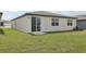 A well-kept lawn with sliding glass door access to the house, situated on a concrete pad at 31673 Wild Grape Sw Ln, Brooksville, FL 34602