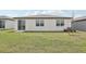 A well maintained backyard with ample grass space, sliding door and newly planted tree at 31673 Wild Grape Sw Ln, Brooksville, FL 34602