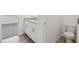 Bathroom featuring a granite double vanity, and toilet with tile floors and adjacent bedroom at 31673 Wild Grape Sw Ln, Brooksville, FL 34602
