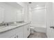 Bathroom features double sink vanity with granite counters and a shower-tub combination at 31673 Wild Grape Sw Ln, Brooksville, FL 34602