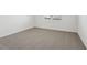 This bedroom features neutral carpet, white walls, and a window for natural light at 31673 Wild Grape Sw Ln, Brooksville, FL 34602