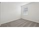 This bedroom features neutral carpet, white walls, and a window for natural light at 31673 Wild Grape Sw Ln, Brooksville, FL 34602