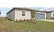 Exterior shot showing a neatly landscaped lawn and the home's architectural details at 31673 Wild Grape Sw Ln, Brooksville, FL 34602