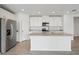 Spacious kitchen with white cabinets, stainless steel appliances, and granite countertops at 31673 Wild Grape Sw Ln, Brooksville, FL 34602