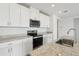 Modern kitchen features granite countertops, stainless steel appliances, and ample cabinet space at 31673 Wild Grape Sw Ln, Brooksville, FL 34602