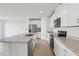 Bright kitchen features stainless steel appliances, granite countertops, and a large center island at 31673 Wild Grape Sw Ln, Brooksville, FL 34602