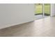 Living room featuring neutral tile floors and sliding glass doors at 31673 Wild Grape Sw Ln, Brooksville, FL 34602