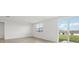 Bright living room featuring neutral tile floors and sliding glass doors to the backyard at 31673 Wild Grape Sw Ln, Brooksville, FL 34602