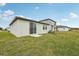 New construction home with a lawn and a sliding glass doors at 3561 Moscato Dr, Brooksville, FL 34602