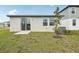 New construction home with a lawn and sliding glass doors leading to patio at 3561 Moscato Dr, Brooksville, FL 34602
