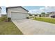 A modern one-story home with a long driveway and a two-car garage at 3561 Moscato Dr, Brooksville, FL 34602