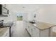 Bright kitchen features granite countertops, stainless appliances, and island with sink, offering a modern and functional space at 3561 Moscato Dr, Brooksville, FL 34602