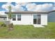 A well maintained backyard with healthy grass and sliding glass doors to the home at 3568 Moscato Dr, Brooksville, FL 34602