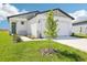 Charming single-story home with a well-manicured lawn, lush landscaping, and a two-car garage at 3568 Moscato Dr, Brooksville, FL 34602