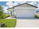Charming single-Gathering home featuring a manicured lawn and attached two-car garage at 3568 Moscato Dr, Brooksville, FL 34602