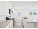Bright kitchen with stainless steel appliances and a large island with a sink at 3568 Moscato Dr, Brooksville, FL 34602