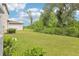 Backyard with green grass and beautiful foliage at 3824 Radiant Mountain Dr, Plant City, FL 33565