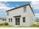 Two story home backyard with large windows and sliding door at 3824 Radiant Mountain Dr, Plant City, FL 33565